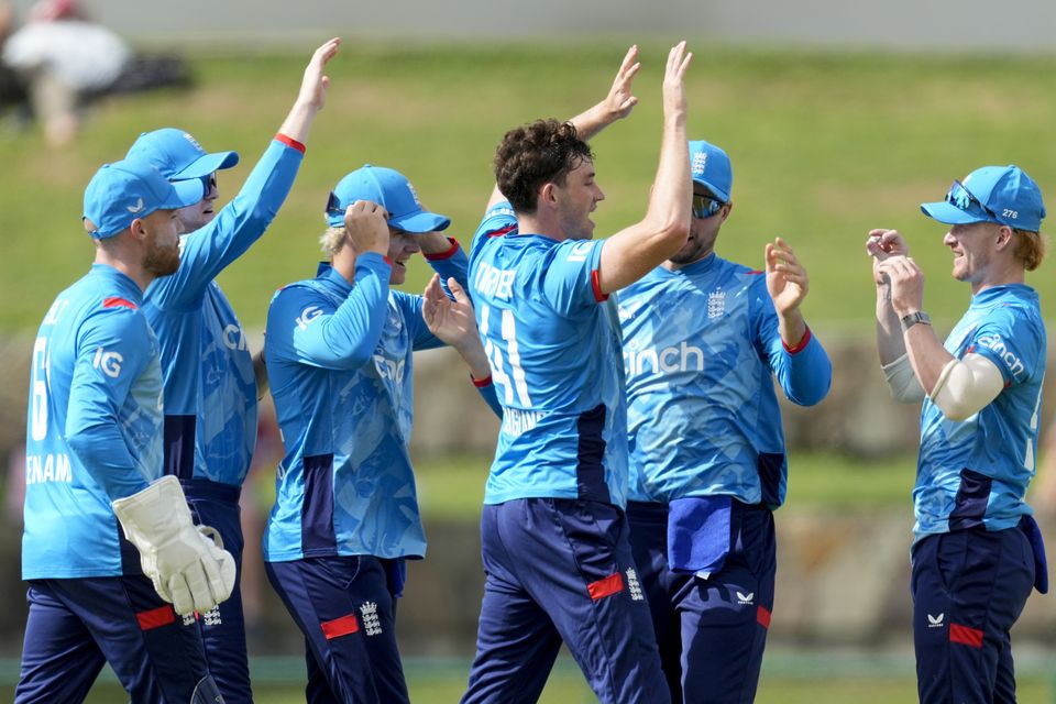 England’s John Turner, centre, celebrates taking the wicket of West Indies’ Brandon King (Ricardo Malazan/AP)