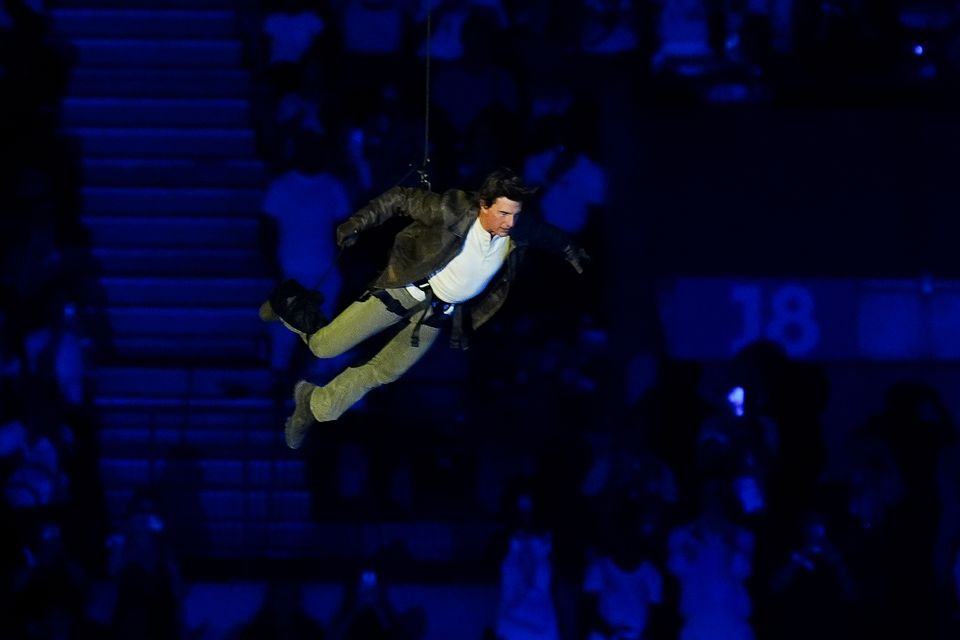 Tom Cruise jumps from the stadium roof during the closing ceremony (David Davies/PA)