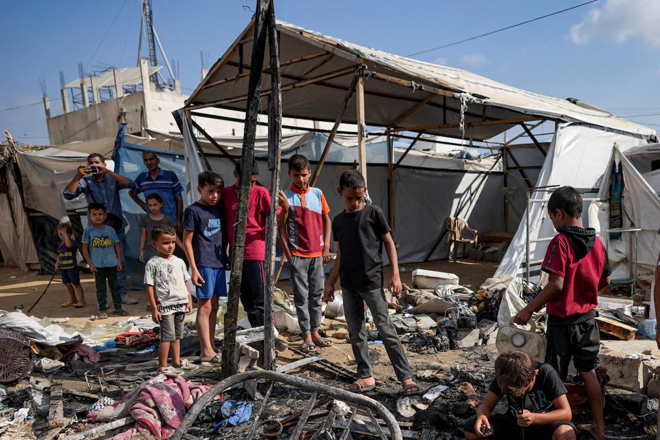 Palestinians inspect the damage at a tent area in the courtyard of Al Aqsa Martyrs hospital (Abdel Kareem Hana/AP)