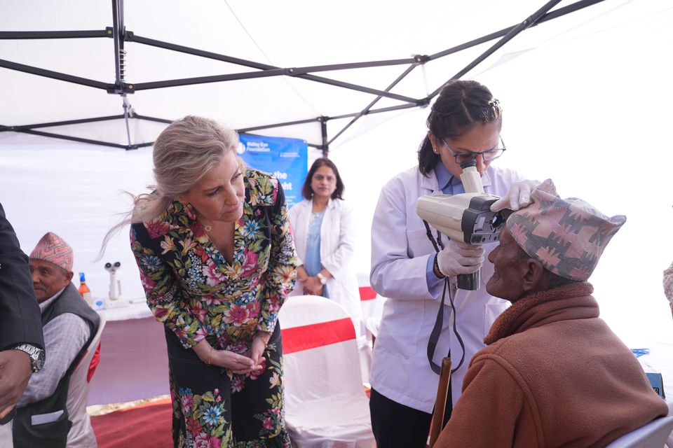 The Duchess of Edinburgh (left) watches a patient receive an eye test during a visit to a hospital (Yui Mok/PA)