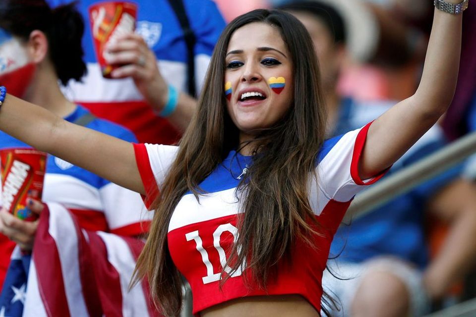 The beautiful game - football fans from around the world -  Portugal supporter dances in the stands before the group G World Cup soccer match between the United States and Portugal at the Arena da Amazonia in Manaus, Brazil, Sunday, June 22, 2014. (AP Photo/Julio Cortez)