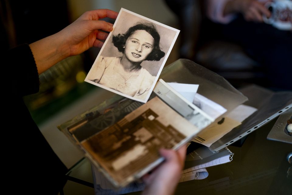 Holocaust survivor Susan Pollack with an old photograph of herself in her north London home (Jordan Pettitt/PA)