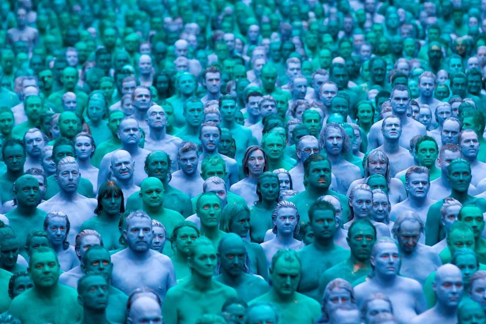 Naked volunteers, painted in blue to reflect the colours found in Marine paintings in Hull's Ferens Art Gallery, participate in US artist, Spencer Tunick's "Sea of Hull" installation in Kingston upon Hull on July 9, 2016. AFP/Getty Images