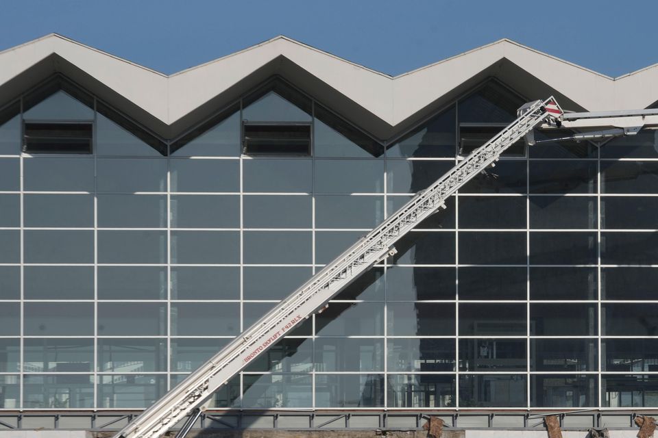 Workers inspect a train station after an outdoor roof collapsed (Darko Vojinovic/AP)