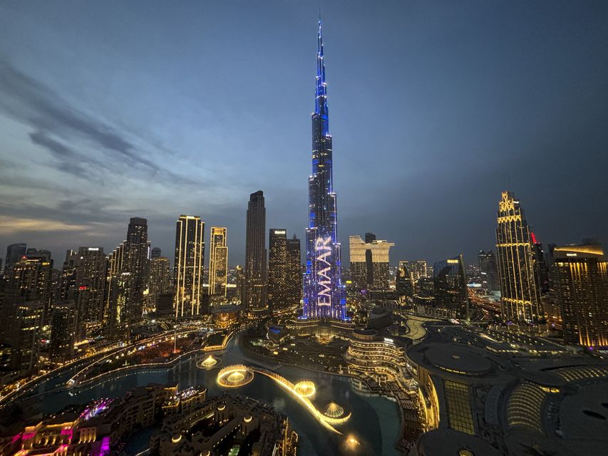 Lights illuminate Burj Khalifa, the world’s tallest building, ahead of the New Year’s Eve celebration, in Dubai (Altaf Qadri/AP)