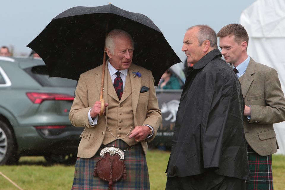 Attendees, including the King, were forced to shelter from the rainy weather (Robert MacDonald/PA)