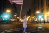 thumbnail: Joseph Eli Libby, 20, of Boston, carries a flag near a makeshift memorial on Boylston Street, near the finish line of the Boston Marathon (AP)