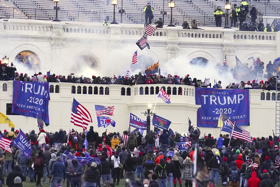 Rioters attempt to storm the US Capitol building on January 6 2021 (John Minchillo/AP)