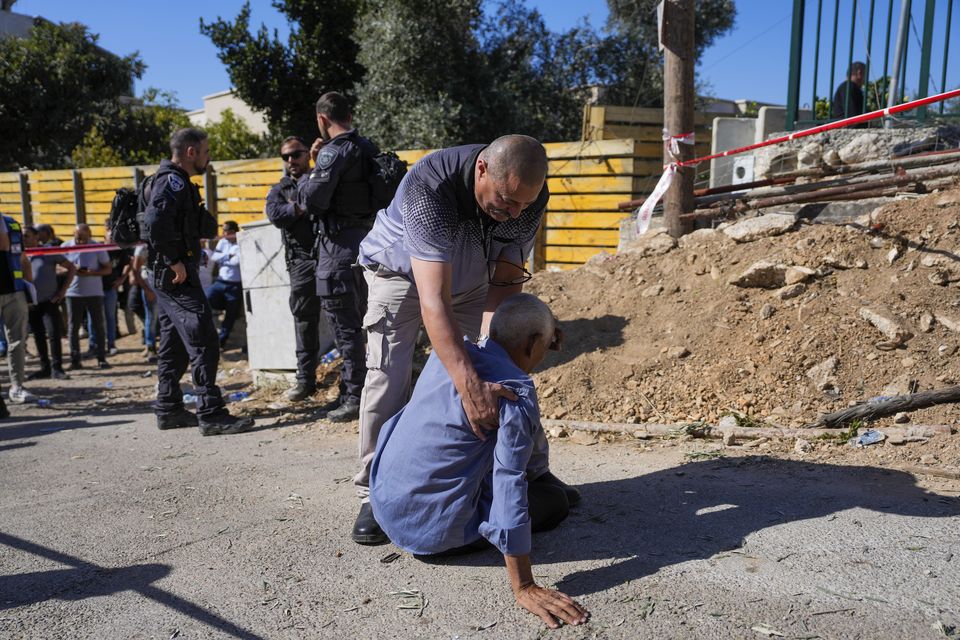 People react at the site where one person was killed after a projectile launched from Lebanon slammed into northern Israel (AP Photo/Ohad Zwigenberg)