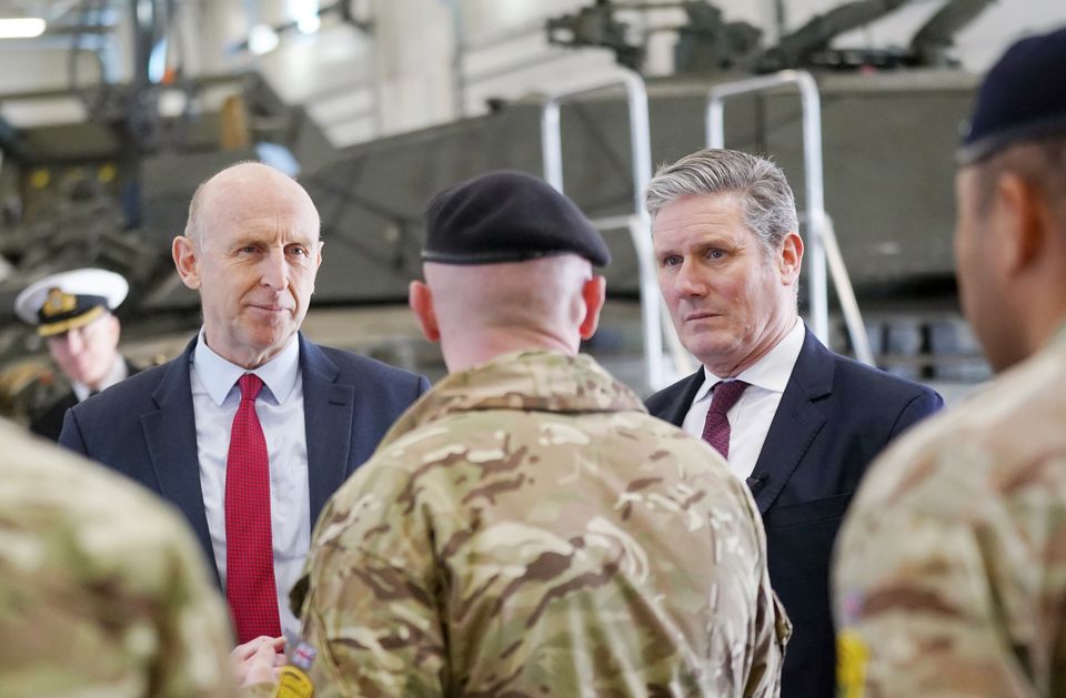 Labour leader Sir Keir Starmer (right) and shadow defence secretary John Healey (left), talk to troops during a visit to Tapa Military Base in Estonia (Victoria Jones/PA)