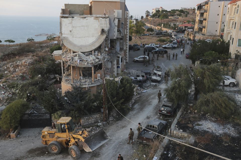 Lebanese soldiers surround a destroyed building in Barja (Mohammed Zaatari/AP)