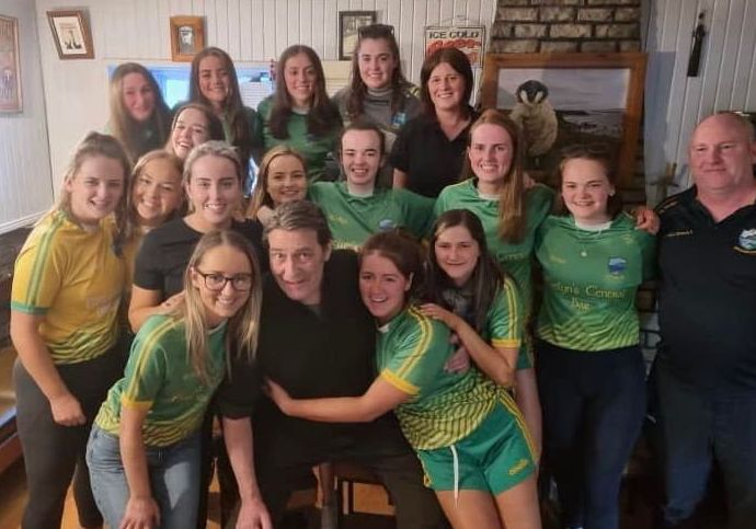 Ciaran Hinds  with members of the Naomh Columba  ladies’ team