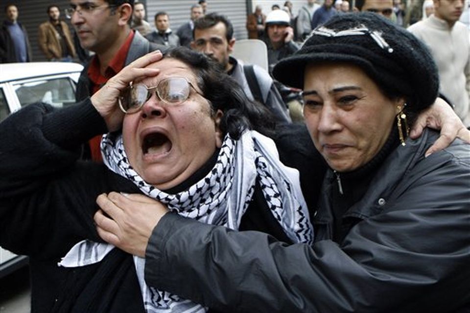 A Palestinian woman cries during a protest in Damascus, Syria on Saturday Dec. 27, 2008 against an Israeli raid on Gaza that killed some 145 Palestinians. Israeli warplanes attacked dozens of security compounds across Hamas-ruled Gaza on Saturday in unprecedented waves of air strikes. Gaza medics said at least 145 people were killed and more than 310 wounded in the single deadliest day in Gaza fighting in recent memory.   (AP Photo/Bassem Tellawi)