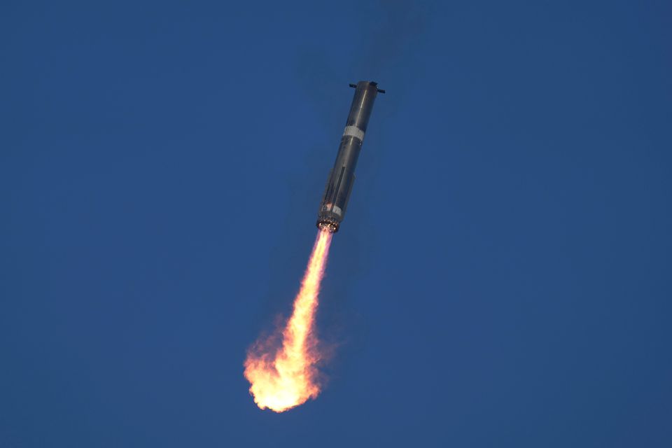 SpaceX’s mega-rocket Starship booster returns to the launch pad during a test flight from Starbase in Boca Chica, Texas (AP/Eric Gay)