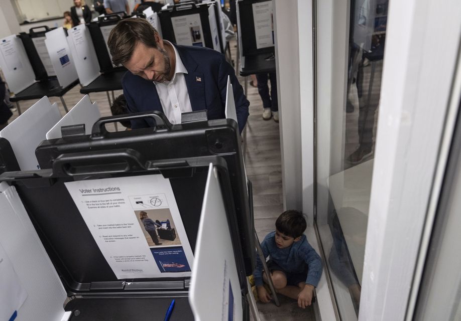 Republican vice presidential nominee Senator JD Vance votes with his son at the St Anthony of Padua Maronite Catholic Church on Election Day in Cincinnati (Carolyn Kaster/AP)