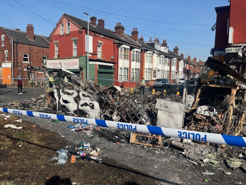 A burnt-out car in the Leeds suburb of Harehills (Katie Dickinson/PA)