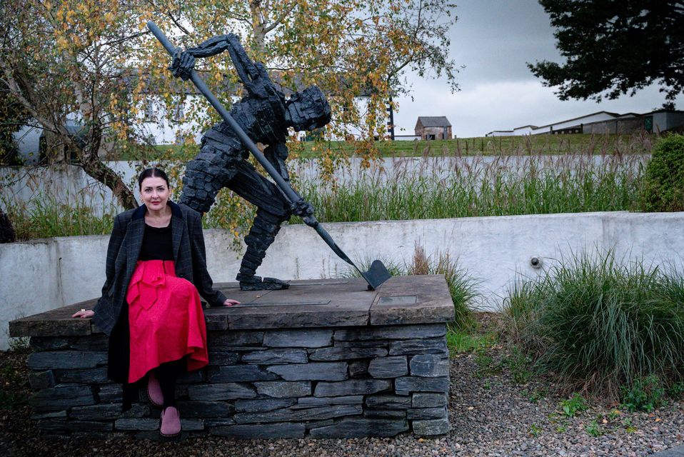 Kathy at the "The Turf Man" bronze statue, inspired by the Seamus Heaney poem "Digging" in Bellaghy, County Londonderry- Courtesy of Tourism Northern Ireland

