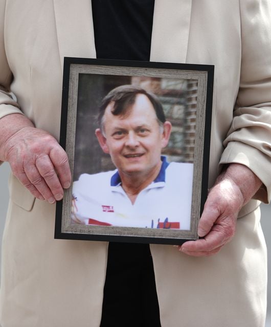 Bridie Brown, the widow of murdered GAA official Sean Brown, holds a picture of him (Liam McBurney/PA)