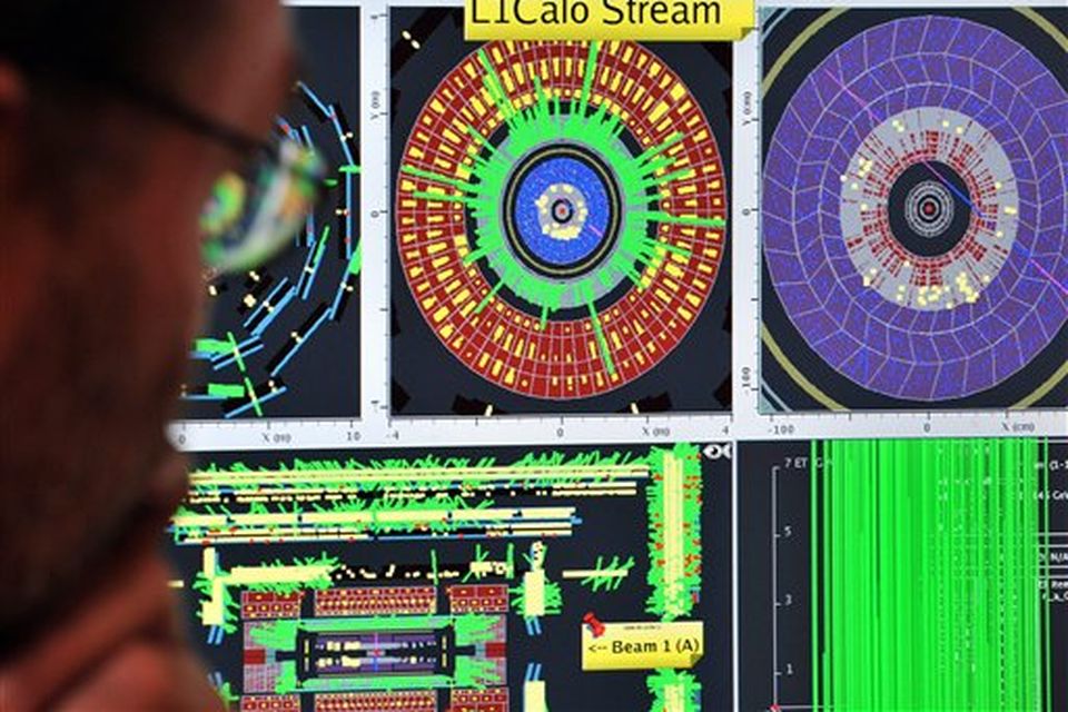 A European Center for Nuclear Research (CERN) scientist controls a computer screen showing traces on Atlas experiment of the first protons injected in the Large Hadron Collider (LHC) during its switch on operation at the Cern's press center on Wednesday, Sept. 10, 2008 near Geneva, Switzerland. Scientists fired a first beam of protons around a 27-kilometer (17 mile) tunnel housing the Large Hadron Collider (LHC). They hope to recreate conditions just after the so-called Big Bang. The international group of scientists plan to smash particles together to create, on a small-scale, re-enactments of the Big Bang. (AP Photo/Fabrice Coffrini, Pool)