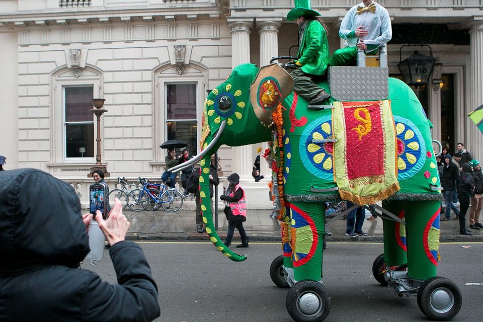 A bystander takes a photo of a elephant float at the Mayor of London's St Patrick's Day Parade and Festival in London. Daniel Leal-Olivas/PA Wire.