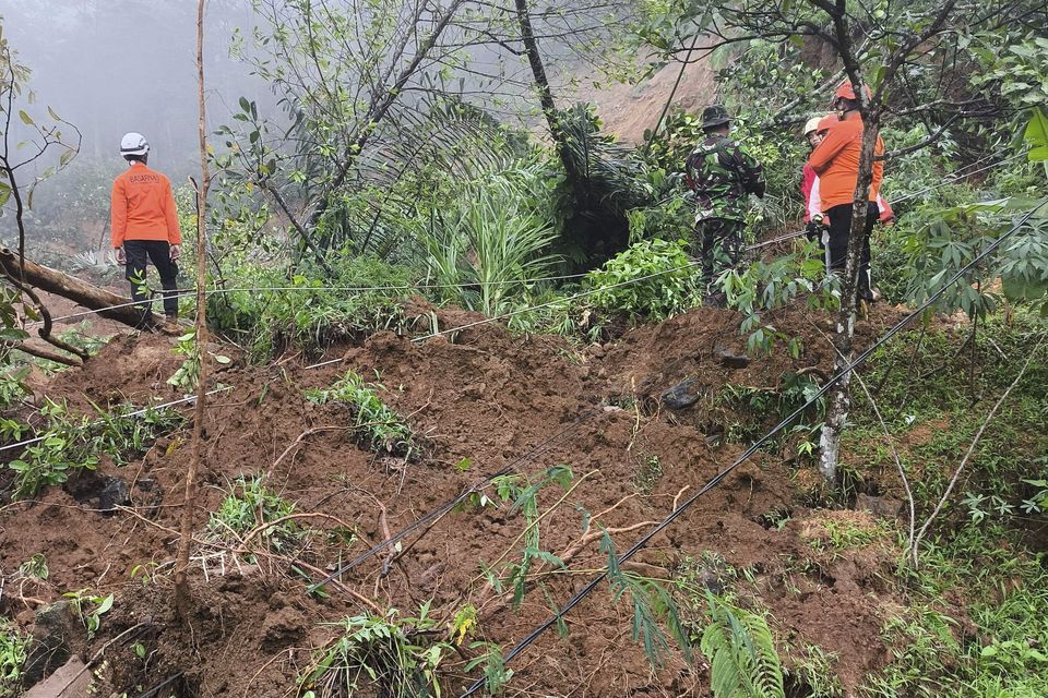 Rescuers search for victims of flash floods which triggered a landslide in Pekalongan, Central Java, Indonesia (BNPB via AP)