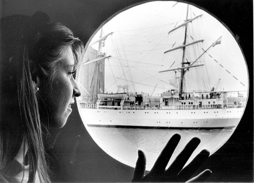 Amanda Suckling waves to the crew of one of the Tall Ships as it makes its way into Pollock Dock