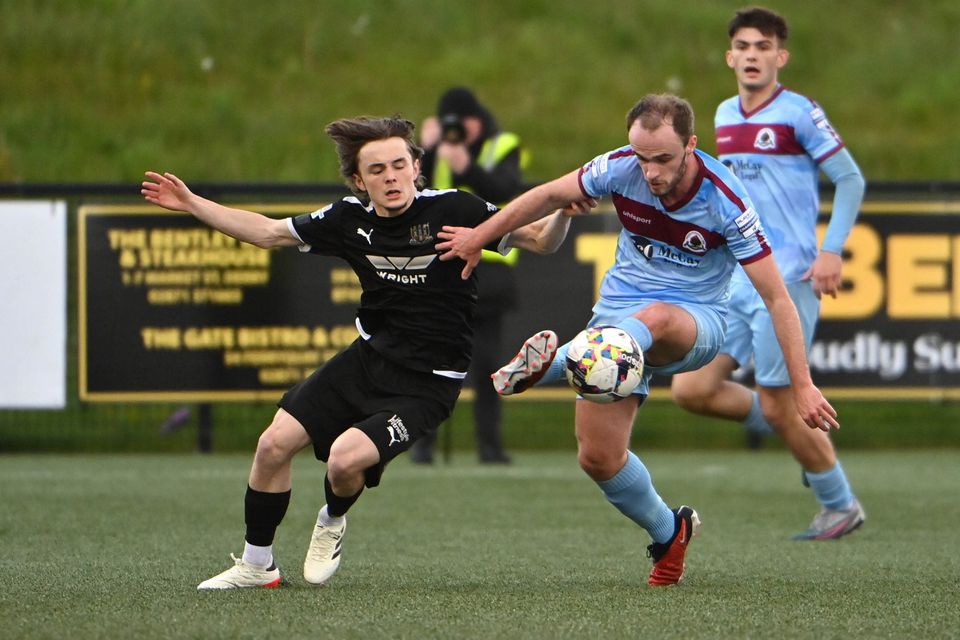 Institute's Conor Quigley tried to fend off Ballymena’s Fraser Taylor