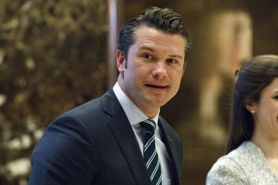 Pete Hegseth walks to an elevator for a meeting with President-elect Donald Trump at Trump Tower (Evan Vucci/AP)