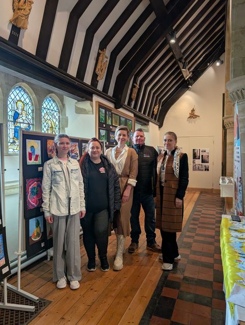 Matt Simmons (second from right) is one of the organisers of the exhibit (Bridge to Unity/PA)