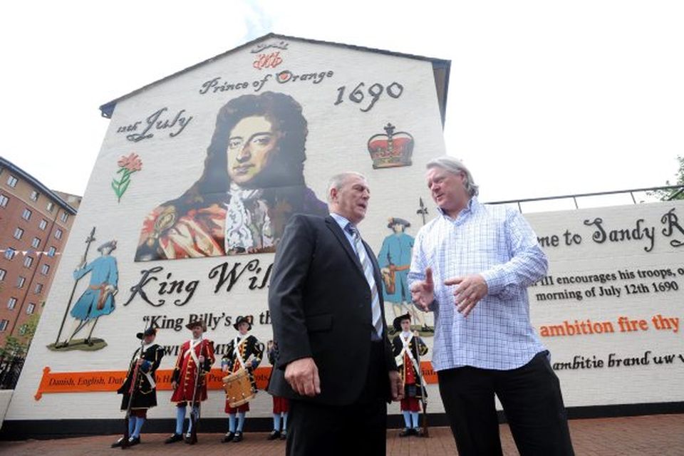 Loyalist Jackie McDonald (left) and artist Ross Wilson at the launch of a new mural in Sandy Row that has replaced a notorious depiction of a UFF gunman