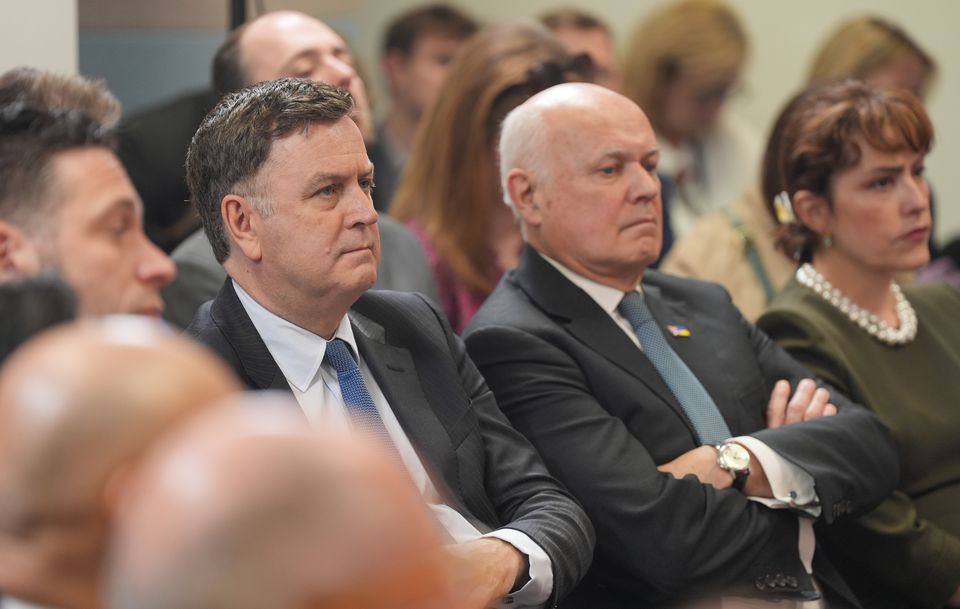 Work and Pensions Secretary Mel Stride (left) and Sir Iain Duncan Smith listening to Prime Minister Rishi Sunak giving his speech (Yui Mok/PA)