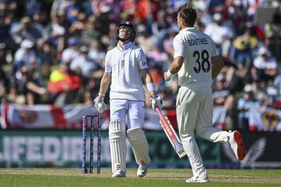 England’s Ollie Pope reacts after he was dismissed by New Zealand’s Tim Southee, right (John Davidson/Photosport/AP)