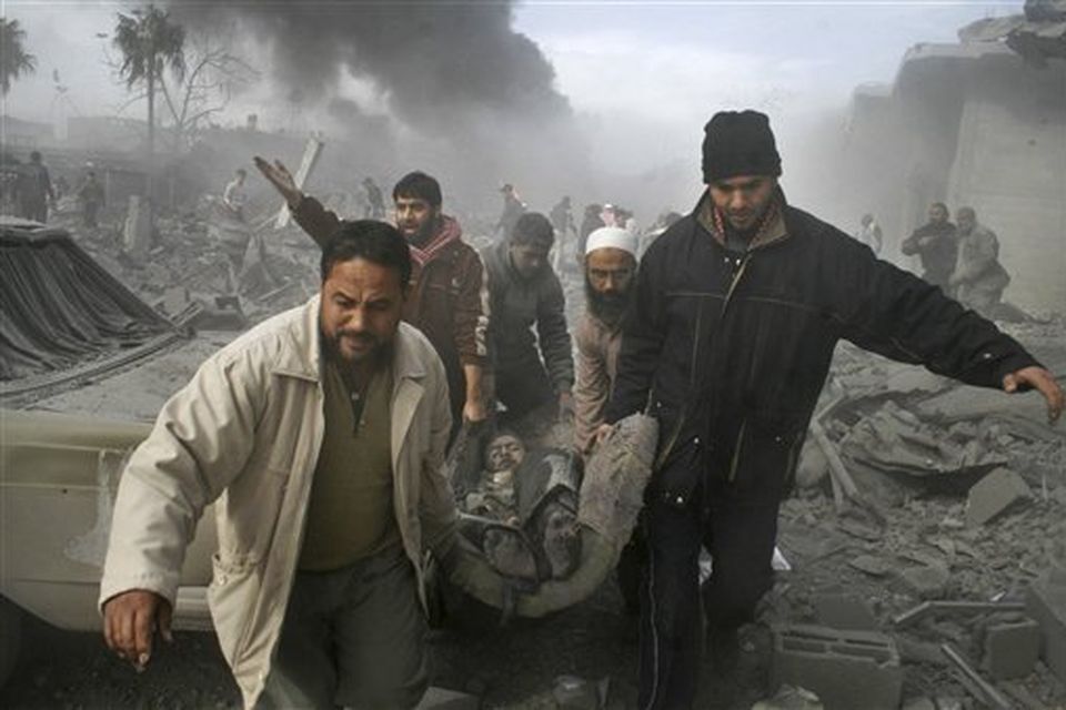 Palestinians carry the body of a Palestinian killed in an Israeli missile strike in Rafah, southern Gaza Strip, Saturday, Dec. 27, 2008. Israeli warplanes demolished dozens of Hamas security compounds across Gaza on Saturday in unprecedented waves of simultaneous air strikes. Gaza medics said more than 120 people were killed and more than 250 wounded. (AP Photo/Hatem Omar)