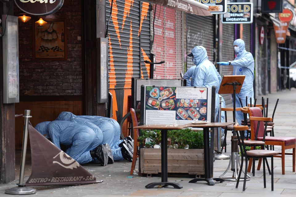 Police forensic officers at the scene in Kingsland High Street (PA)