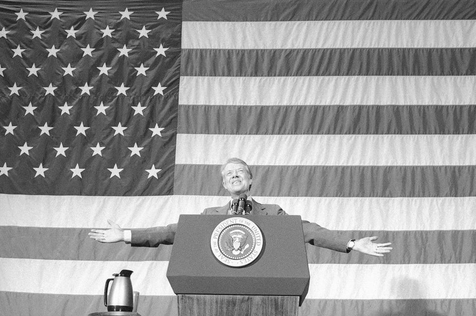 President Jimmy Carter acknowledges the applause of about 1,100 people gathered in the Elk City High School gym for a town meeting in Elk City, Oklahoma (Anonymous/PA)