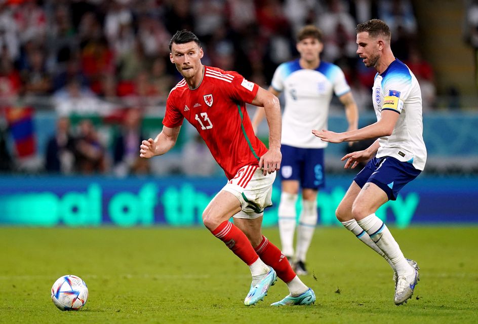 Kieffer Moore, left, battles with England’s Jordan Henderson when the two countries last met at the 2022 World Cup in Qatar (Adam Davy/PA)