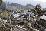 thumbnail: A local resident walks through debris in Rikuzentakata, Iwate, northern Japan Saturday morning, March 12, 2011 after Japan's biggest recorded earthquake slammed into its eastern coast Friday