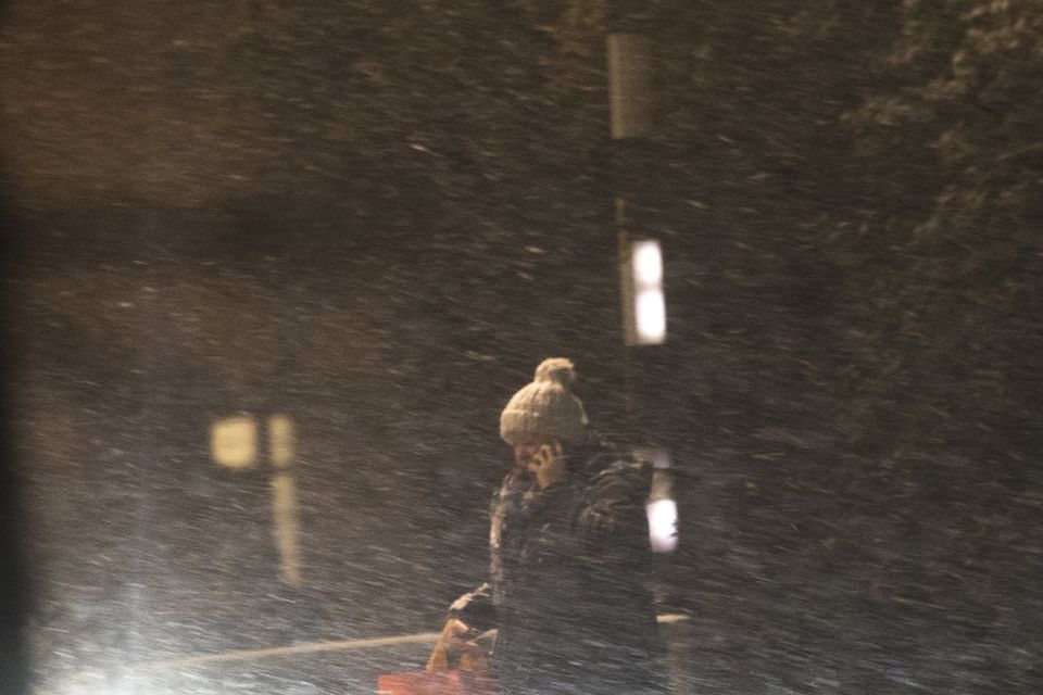 People make their way to work as snow falls over Belfast.
Picture Colm O'Reilly