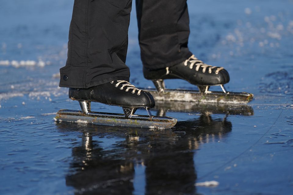 Paul Jansen skates on the frozen flooded field in Upware (Joe Giddens/PA)