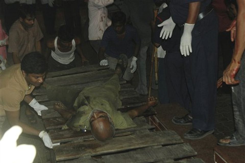 A man injured in a gunbattle is carried to a hospital, at the Chatrapati Shivaji Terminus, in Mumbai, India, Wednesday, Nov. 26, 2008.  Gunmen targeted luxury hotels, a popular tourist attraction and a crowded train station in at least seven attacks in India's financial capital Thursday, wounding 25 people, police and witnesses said. A.N Roy police commissioner of Maharashtra state, of which Mumbai is the capital, said several people had been wounded in the attacks and police were battling the gunmen. (AP Photo)