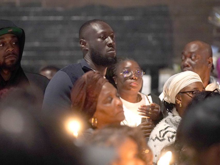 Stormzy (centre) joined people attending a vigil outside the Whitgift shopping centre (Yui Mok/PA)