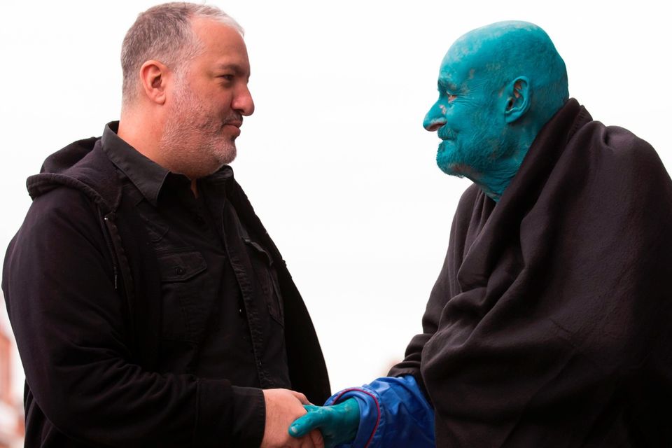 US artist Spencer Tunick (L), shakes hands with 80 year old Belgian, Arizona-based art collector Stephane Janssen who has participated in 20 of Turnick's installations after around 3000 naked volunteers, painted in blue to reflect the colours found in Marine paintings in Hull's Ferens Art Gallery, participate in US artist, Spencer Tunick's "Sea of Hull" installation on the Scale Lane swing bridge in Kingston upon Hull on July 9, 2016. AFP/Getty Images