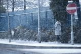 thumbnail: People make their way to work as snow falls over Belfast.
Picture Colm O'Reilly