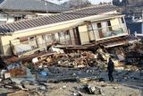 thumbnail: A residents of the seaside town of Yotsukura, northern Japan, walks past damaged homes Monday, March 14, 2011, three days after a giant quake and tsunami struck the country's northeastern coast. (AP Photo/Mark Baker)