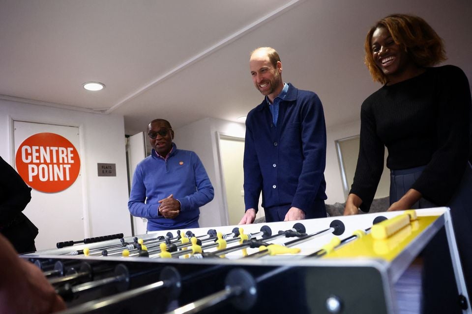 William joins in a game of table football at Centrepoint in Ealing, west London (Hannah McKay/PA)