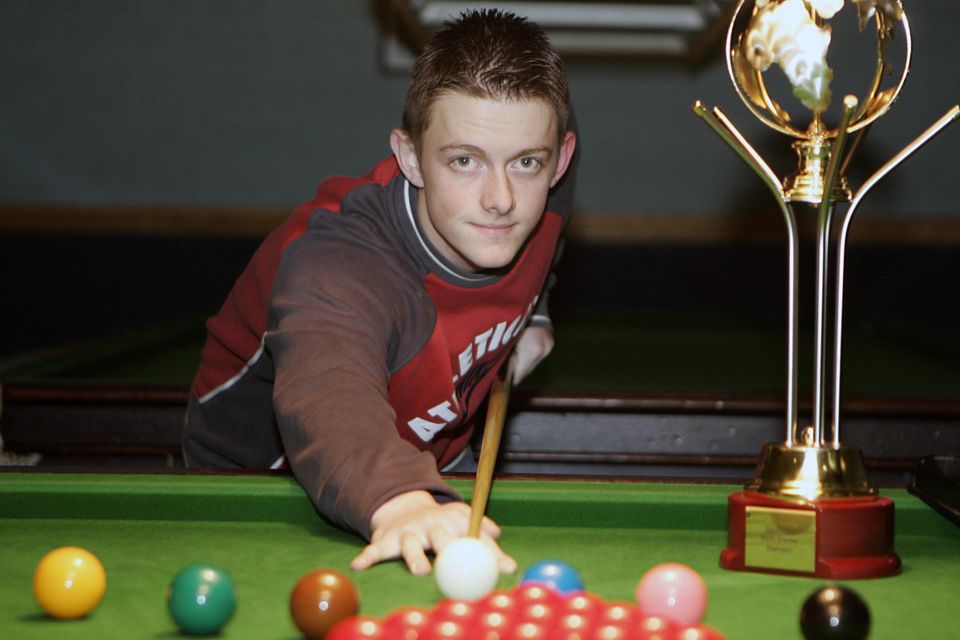 The young star player in 2004 with his World Championship trophy back in his local snooker hall in Antrim