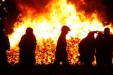 thumbnail: A firefighter attends to  an 11th night Bonfire in the Sandy Row area of Belfast. Pic: Niall Carson/PA Wire