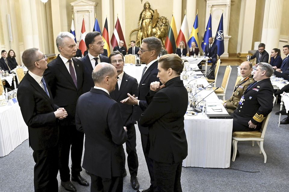 German Chancellor Olaf Scholz, front left, and Denmark’s Prime Minister Mette Frederiksen, front right, talk during a summit of the Baltic Sea Nato countries in Helsinki, Finland (Vesa Moilanen/Lehtikuva/AP)