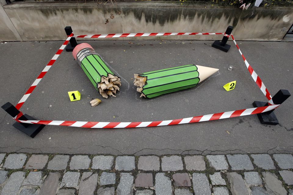 FILE – An art installation showing a broken pencil is displayed on the pavement near the Charlie Hebdo office in Paris (Francois Mori/AP)