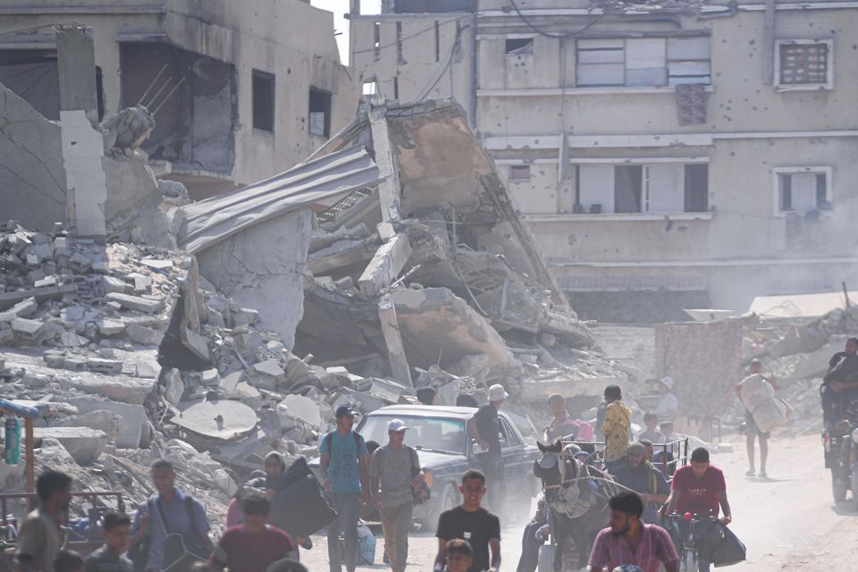 Palestinians displaced by the Israeli air and ground offensive on the Gaza Strip flee from parts of Khan Younis (Abdel Kareem Hana/AP)